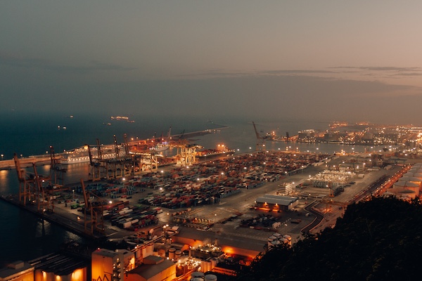 distant-shot-port-with-boats-loaded-with-cargo-shipment-nighttime.jpg